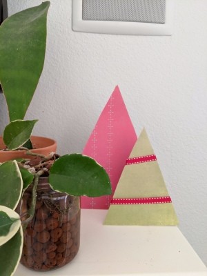 Minimal Cardboard Christmas Tree Decoration - two trees next to a plant on the mantle