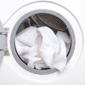 An open dryer with a white towel.