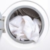 An open dryer with a white towel.