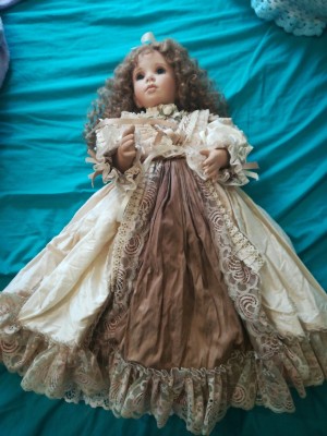 Value of an Ashton Drake Porcelain Doll - doll wearing a long dress with taupe lace