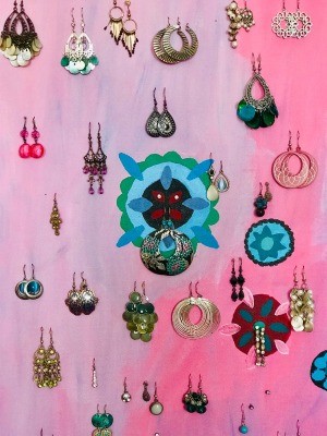 Hanging earrings stored on a piece of fabric.