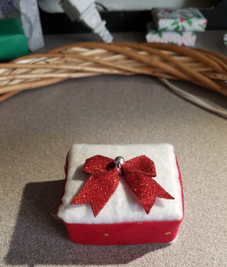 Mini Gift Wreath - closeup of a mini gift with a leftover mini bow on top