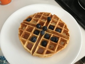 baked Waffle on plate with syrup & blueberries