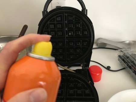 spraying waffle iron
