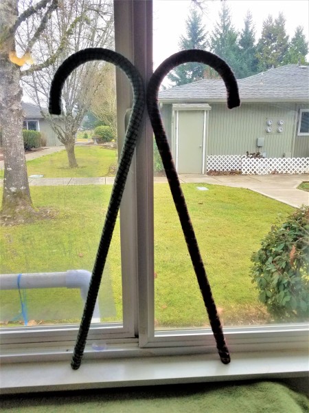 Ripped Fabric Wrapped Faux Candy Canes - two canes propped up on window ledge