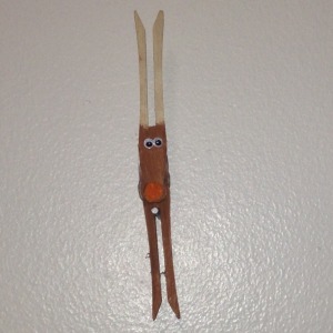 Clothespin Reindeer - reindeer ornaments hanging on the wall