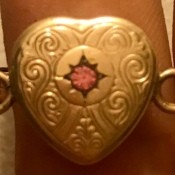 Identifying a Bracelet - gold link bracelet with heart in center set with a pink stone