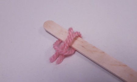 Wood and Yarn Centipede - bring ends over the stick and put though the loop