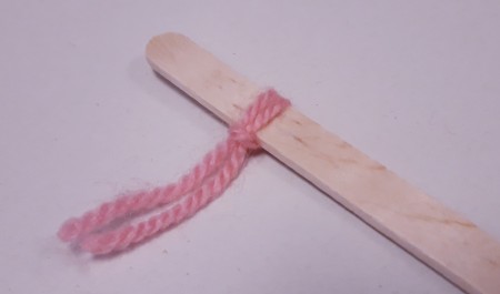 Wood and Yarn Centipede - yarn ends pulled through the loop