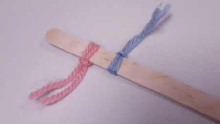 Wood and Yarn Centipede - add the second piece of yarn tying off to the opposite side