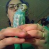 Parakeet Molting After Laying Eggs - woman holding a parakeet with bare spots