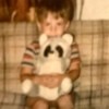 Identifying a Stuffed Raccoon - very fuzzy photo of a young boy holding a stuffed raccoon
