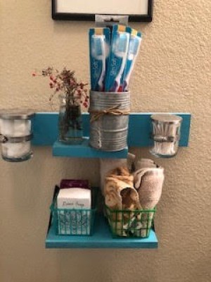 A set of organized small shelves in a bathroom.