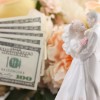 Bride and groom cake topper with cash.
