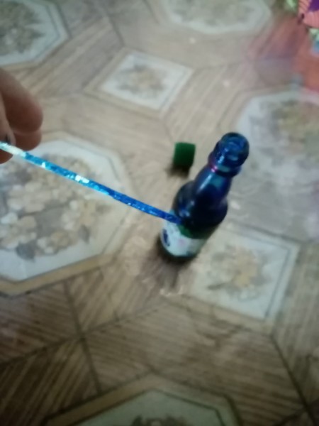 A bottle of blue dye for coloring the meringue.