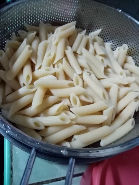 cooked Penne pasta in strainer