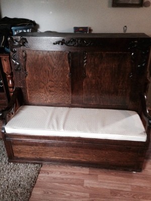 Value of a Foldout Bed - fold out bed with tall wooden headboard with carved decorations on headboard and arms