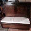 Value of a Foldout Bed - fold out bed with tall wooden headboard with carved decorations on headboard and arms