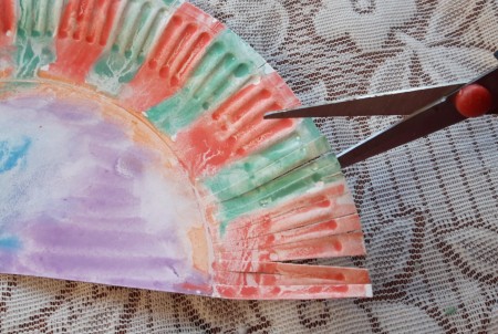 Paper Plate Hedgehog - cut in from the edges on the paint plate making fringe