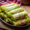 A plate of uncooked cabbage rolls.