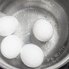 Eggs being hard boiled in water.