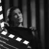 A black and white movie behind a movie clapboard.