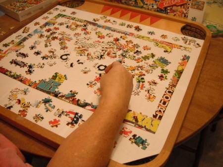 A game board being used to assemble a puzzle.