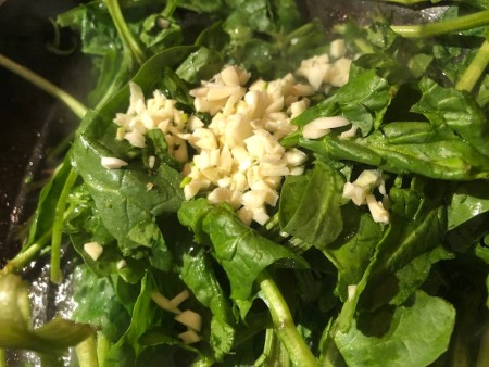 cooking Spinach & garlic in bacon pan