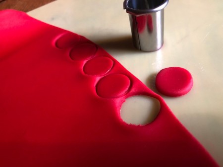 UFO Cow Abduction Cake - red fondant rolled out and cut into small circles