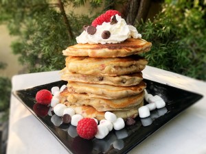 Raspberry Marshmallow Chocolate Chip Pancakes stacked on plate
