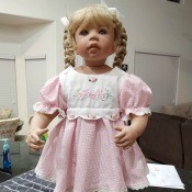 Identifying a Porcelain Doll - doll with blond braids and a pink dress