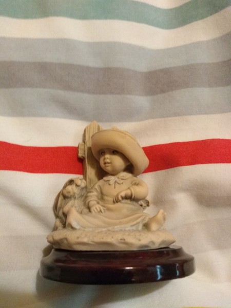 Identifying a Giuseppe Armani Figurine - figurine mounted on round brown base, child sitting in front of a picket fence