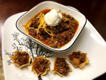 Chili in bowl with cheese & dollop of sour cream