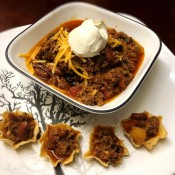 Chili in bowl with cheese & dollop of sour cream