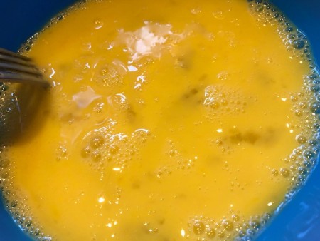mixing scrambled eggs