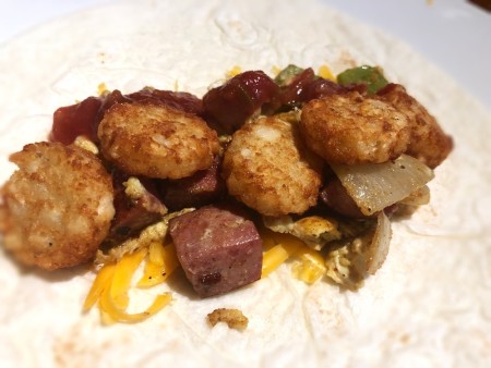 Tater Tots on cheese, egg, veggies & Burrito