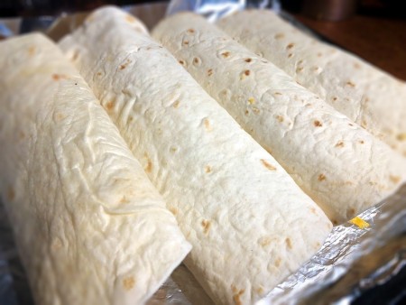 rolled Burritos on foil lined baking pan