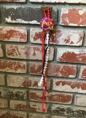 Wall Shell Decoration for Valentine's Day - hanging on a brick fireplace