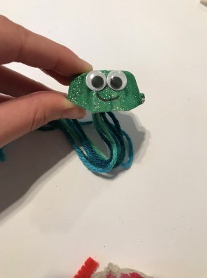 Making an Egg Carton Octopus - green glitter painted octopus with googly eyes