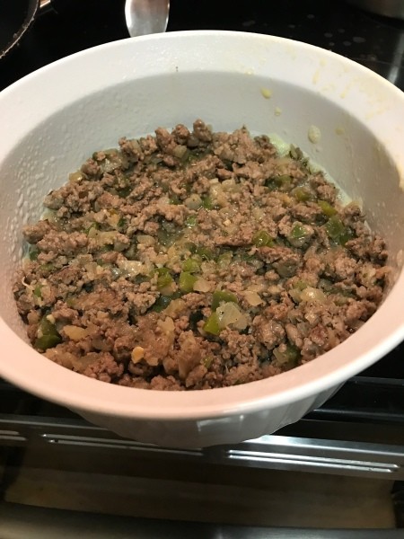 cooked meat, peppers & onions in bowl