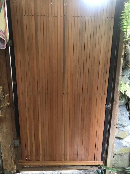 Custom Bathroom Door Design - wooden slats nailed to the door