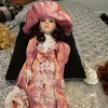 Selling Porcelain Dolls - doll wearing a long peach colored dress trimmed with lace