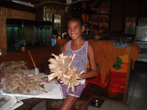 Dried Banana Leaf Crown - smiling young girl holding the finished crown