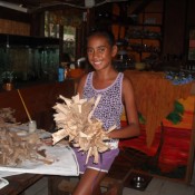 Dried Banana Leaf Crown - smiling young girl holding the finished crown