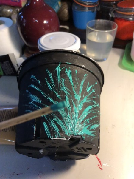 Decorative Planter Pots - using a bamboo stick to create an abstract leaf pattern on a black pot