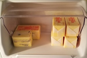 Cubes of butter in the butter section of a refrigerator.