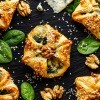 A selection of spinach pastry appetizers.