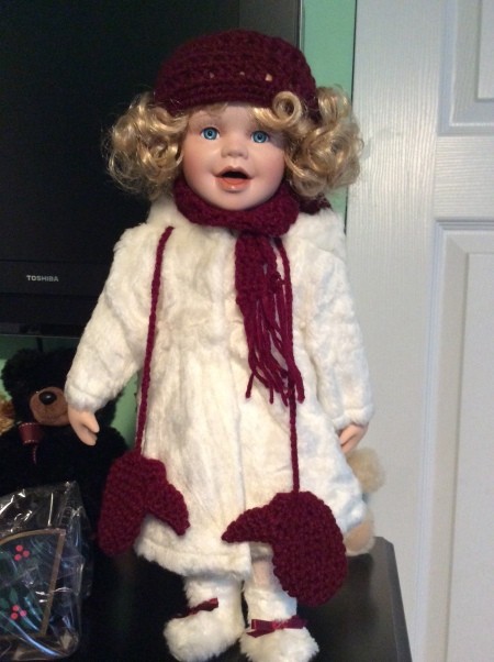 Value of a Heritage Signature Collection Doll - doll wearing a white fuzzy coat with a maroon hat, scarf, and mittens