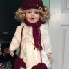 Value of a Heritage Signature Collection Doll - doll wearing a white fuzzy coat with a maroon hat, scarf, and mittens