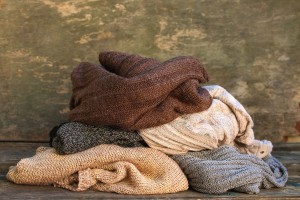 Recycle Old Sweaters into New Clothing - pile of sweaters
